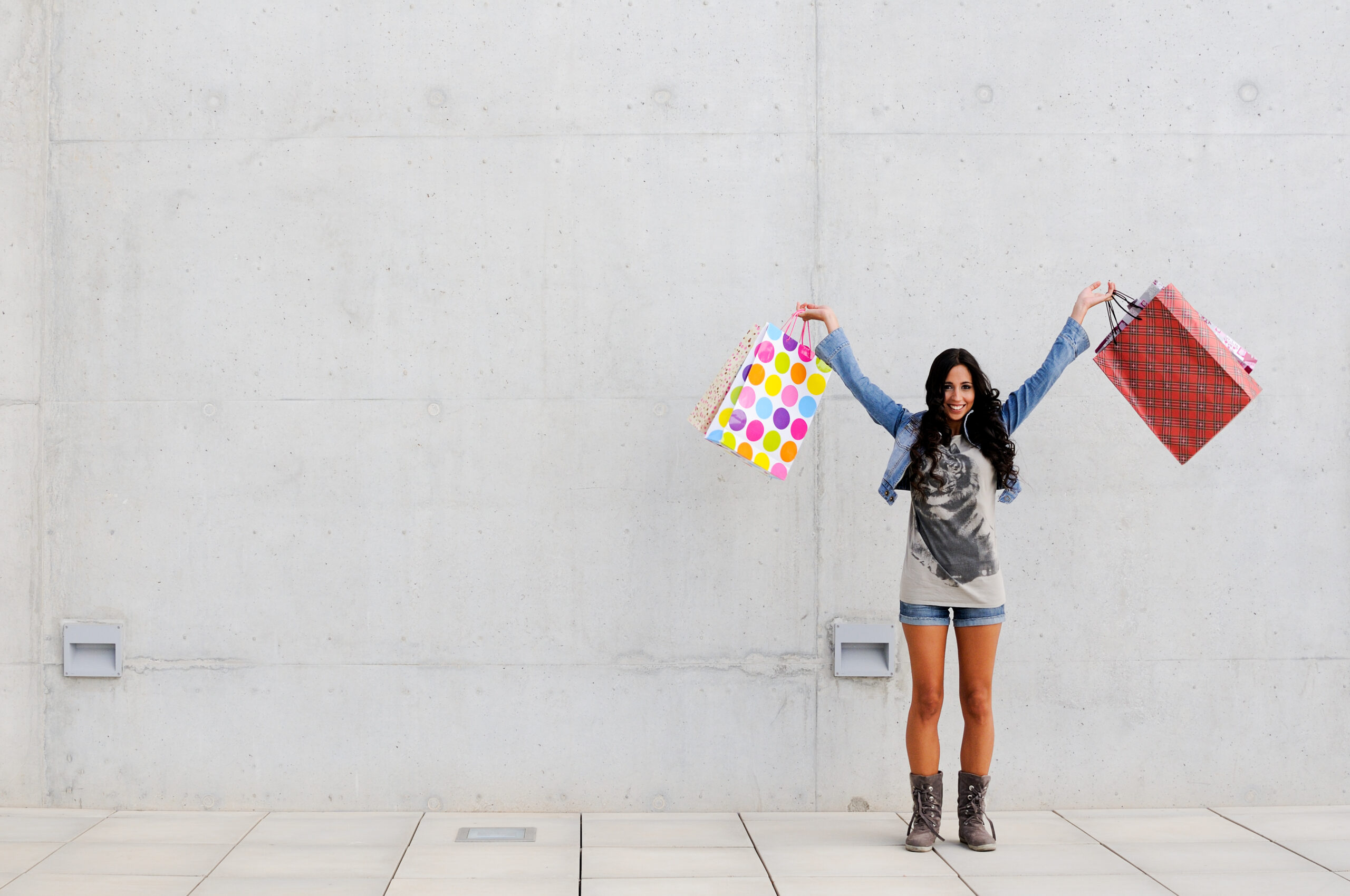 Attractive young girl with shopping bags in the street